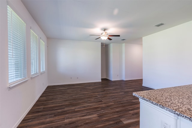 unfurnished living room with ceiling fan and dark hardwood / wood-style floors