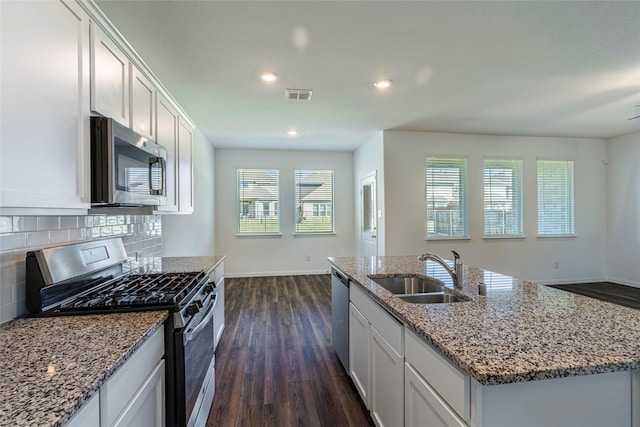 6049 Pensby Dr, Celina, TX 76227 - kitchen featuring stainless steel appliances, dark wood-type flooring, backsplash, a sink, and visible vents