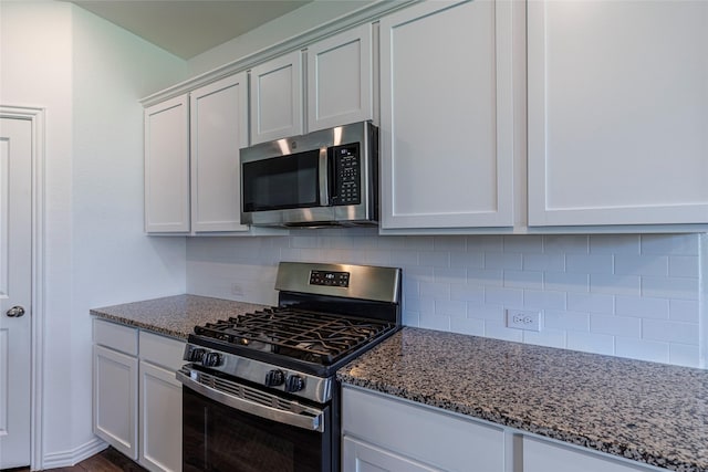 6049 Pensby Dr, Celina, TX 76227 - kitchen with dark stone counters, white cabinets, tasteful backsplash, and appliances with stainless steel finishes