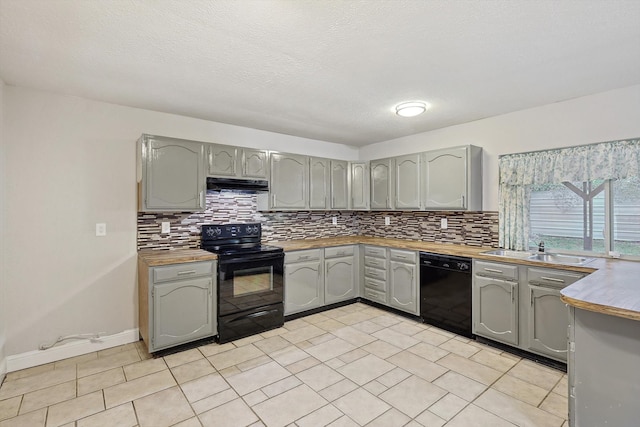 kitchen with gray cabinetry, sink, tasteful backsplash, and black appliances