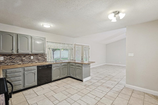 kitchen with kitchen peninsula, tasteful backsplash, a textured ceiling, black appliances, and butcher block counters