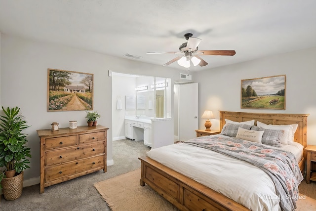 bedroom featuring carpet, ensuite bath, and ceiling fan