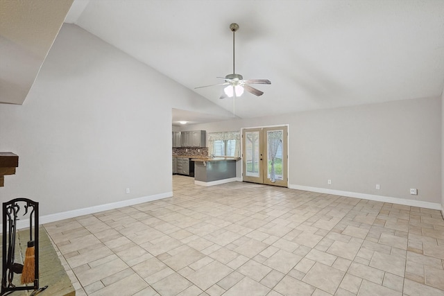 unfurnished living room with ceiling fan, light tile patterned floors, and high vaulted ceiling