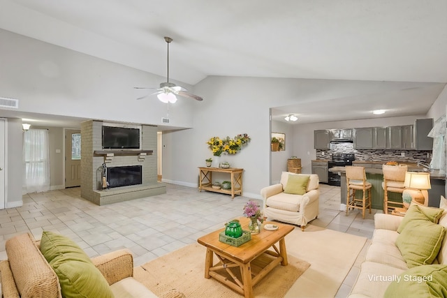 tiled living room with high vaulted ceiling, a wealth of natural light, ceiling fan, and a fireplace