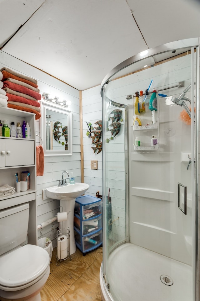 bathroom with wooden walls, toilet, and an enclosed shower