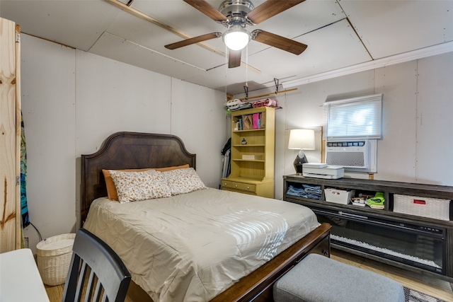 bedroom featuring ceiling fan, cooling unit, and ornamental molding