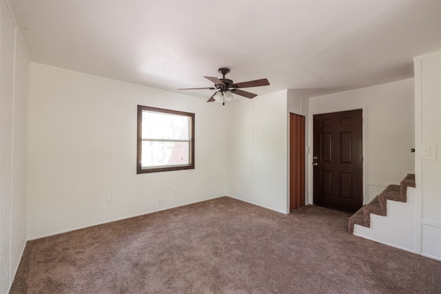 empty room with ceiling fan and carpet flooring