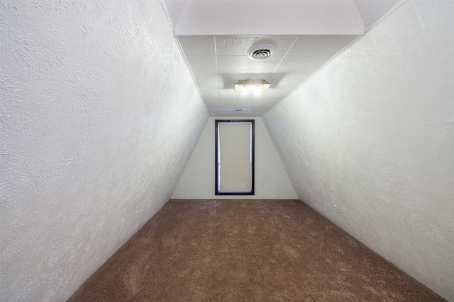 interior space featuring lofted ceiling and carpet flooring