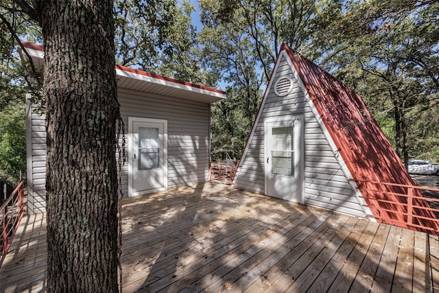 wooden terrace featuring an outbuilding