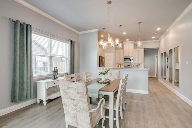 dining area with light hardwood / wood-style flooring, crown molding, and a notable chandelier