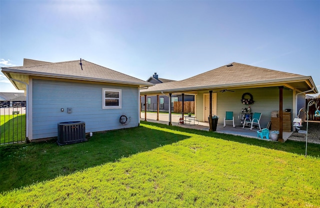 rear view of house with a lawn, a patio area, and central AC unit