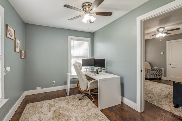 office area featuring dark wood-style floors, ceiling fan, and baseboards