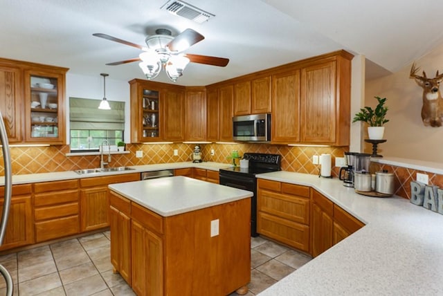 kitchen featuring stainless steel appliances, sink, light tile patterned floors, decorative backsplash, and pendant lighting