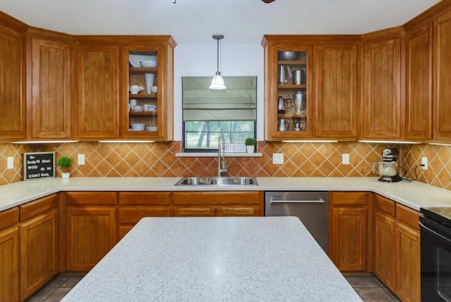 kitchen with stainless steel dishwasher, light tile patterned flooring, sink, and hanging light fixtures