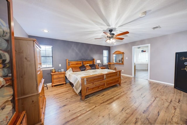 bedroom with ceiling fan, light hardwood / wood-style flooring, and multiple windows