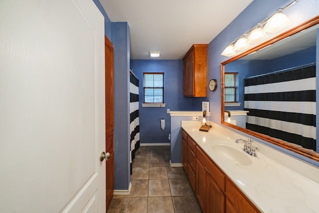 bathroom with tile patterned floors, vanity, and a shower with shower curtain