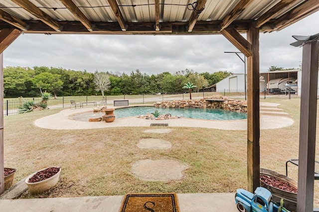 view of pool with a patio and pool water feature