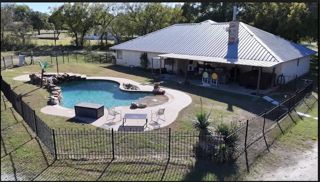 view of pool with a patio area and a lawn