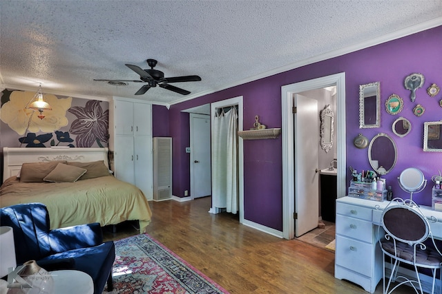 bedroom featuring a textured ceiling, hardwood / wood-style flooring, connected bathroom, crown molding, and ceiling fan