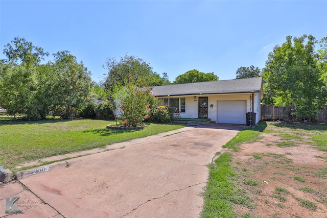 ranch-style house with a garage and a front yard