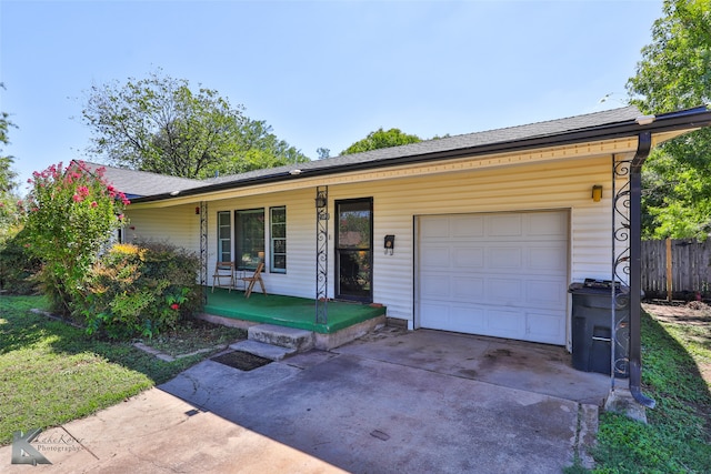 ranch-style home featuring a porch and a garage