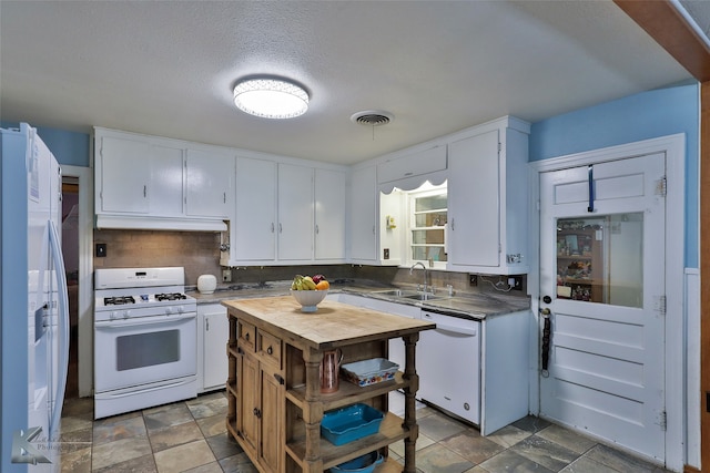 kitchen with tasteful backsplash, white cabinets, white appliances, a textured ceiling, and sink