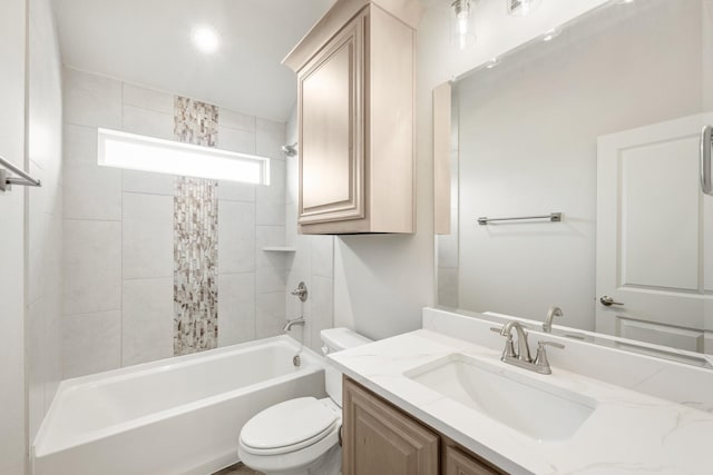 full bathroom with tiled shower / bath combo, vanity, and toilet