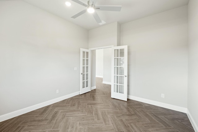 spare room featuring dark parquet flooring, french doors, and ceiling fan