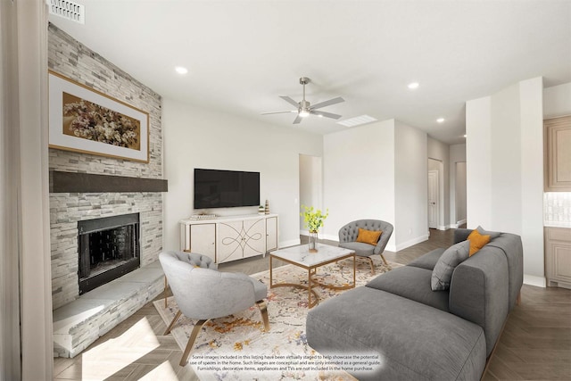 living room featuring a stone fireplace, light parquet floors, and ceiling fan