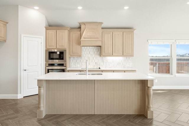 kitchen featuring built in microwave, parquet flooring, sink, and oven