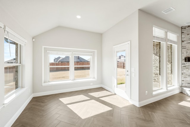 interior space with lofted ceiling and light parquet floors