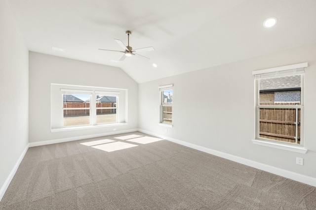 empty room featuring carpet floors, ceiling fan, and vaulted ceiling