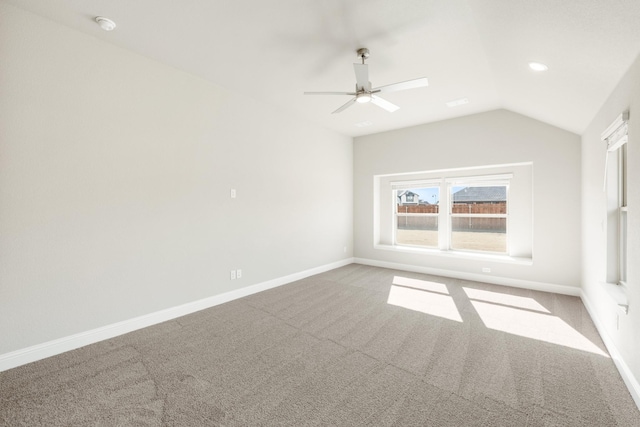 unfurnished room featuring lofted ceiling, light carpet, and ceiling fan