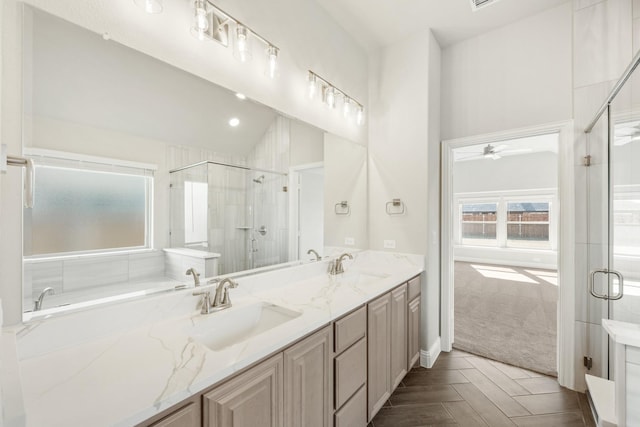 bathroom featuring plus walk in shower, vaulted ceiling, vanity, and parquet flooring