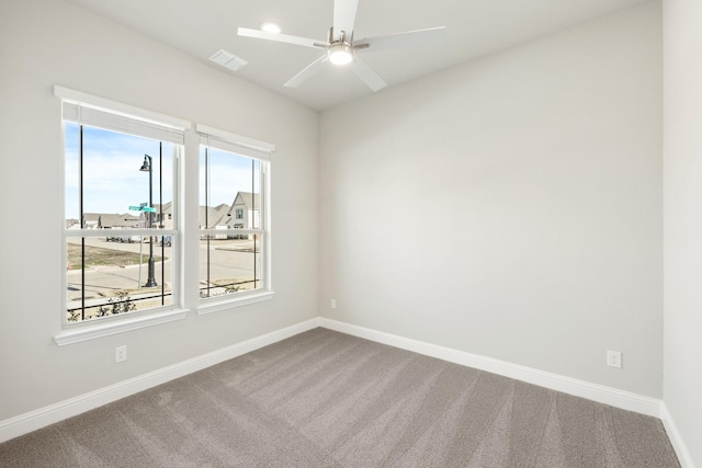 carpeted spare room with ceiling fan