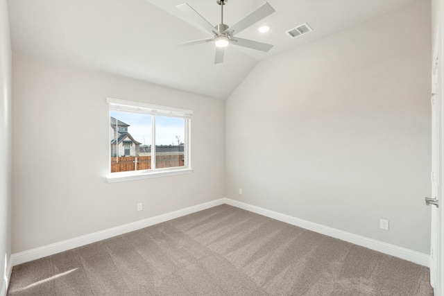 empty room with vaulted ceiling, ceiling fan, and carpet