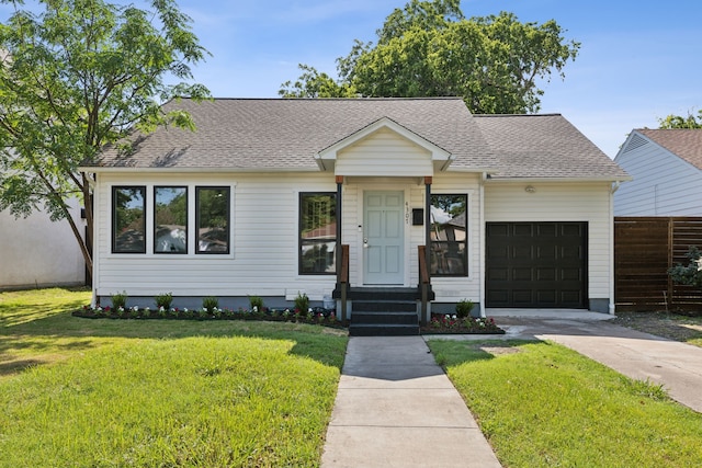 view of front of property with a front lawn and a garage