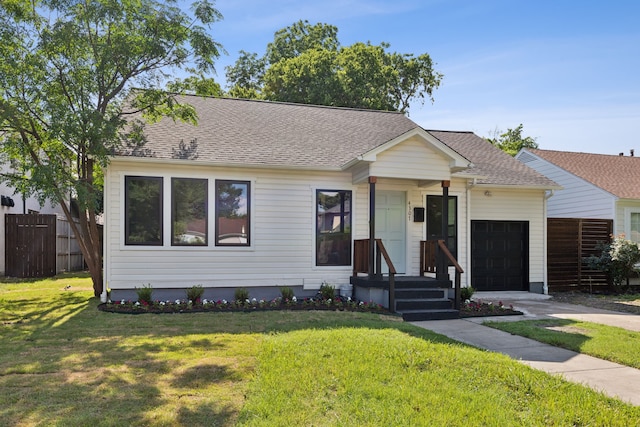 ranch-style house with a garage and a front lawn