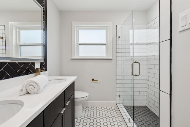 bathroom featuring tile patterned floors, a shower with door, vanity, and toilet