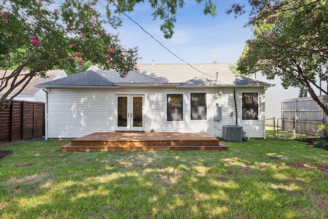 back of property with french doors, central air condition unit, a deck, and a yard