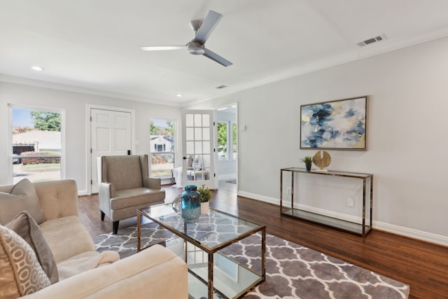 living room featuring ornamental molding, ceiling fan, and dark hardwood / wood-style floors