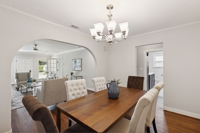 dining space with ceiling fan with notable chandelier, crown molding, and dark wood-type flooring