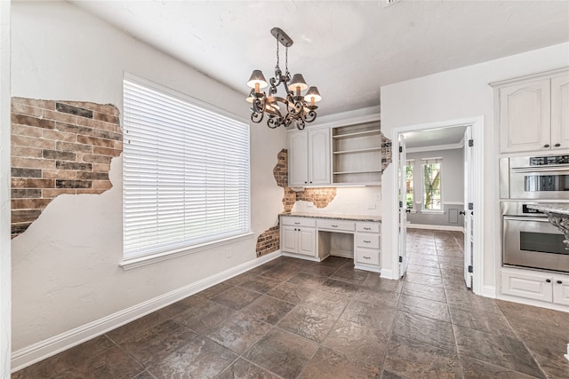 kitchen featuring hanging light fixtures, double oven, decorative backsplash, and white cabinets