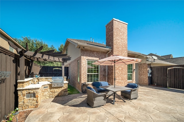 view of patio featuring area for grilling, an outdoor hangout area, a pergola, and exterior kitchen