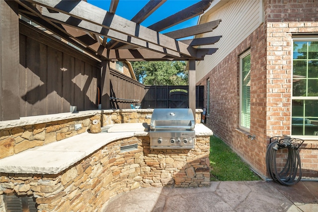 view of patio / terrace with area for grilling, grilling area, and a pergola