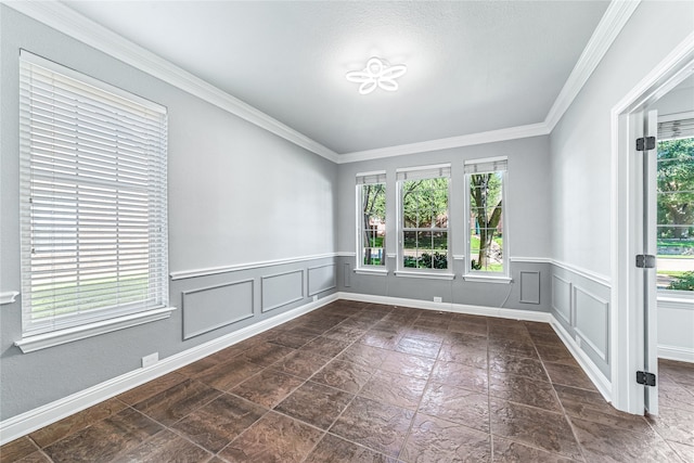 empty room featuring plenty of natural light and crown molding