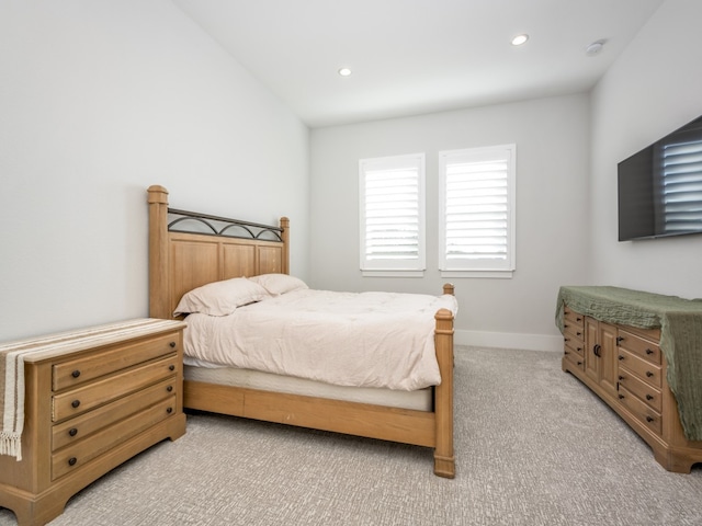 bedroom featuring light carpet