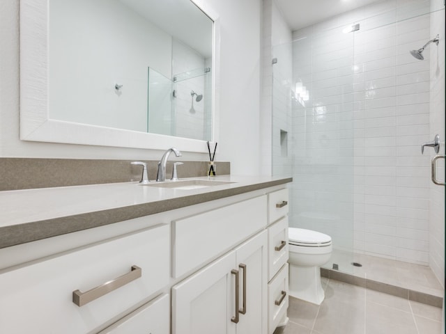 bathroom featuring vanity, a shower with shower door, toilet, and tile patterned flooring