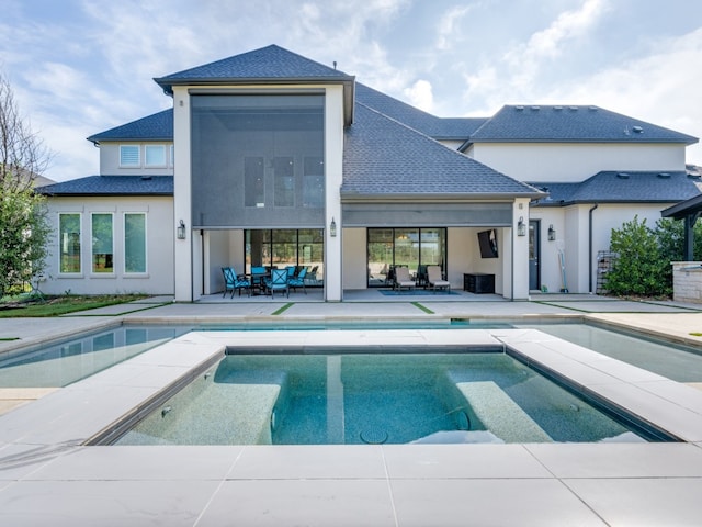 view of pool featuring a hot tub and a patio area