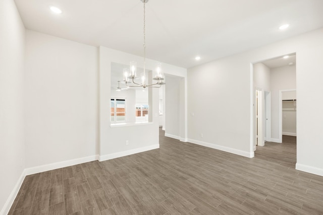 unfurnished dining area with dark wood-type flooring and a chandelier